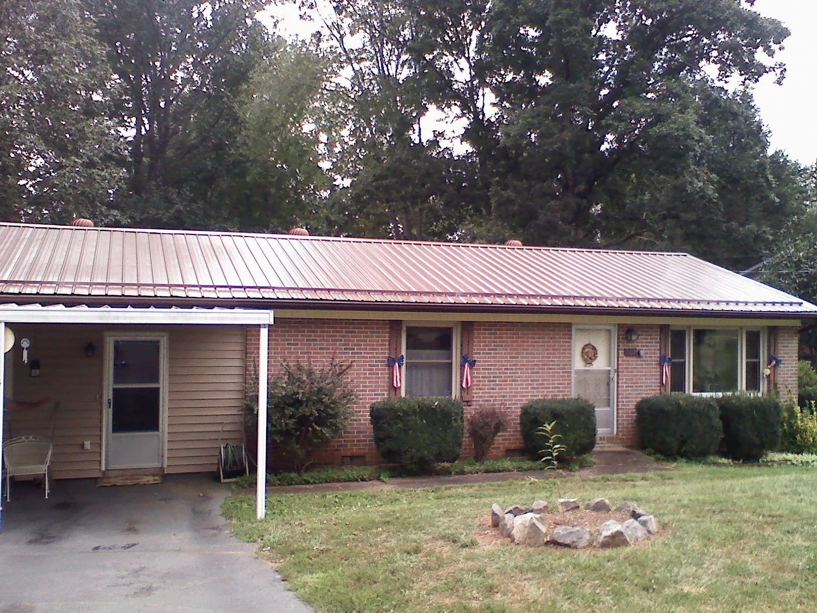 Bronze metal roof and carport on a brick ranch home — Roof Repair work by our crew in Lookout Mountain