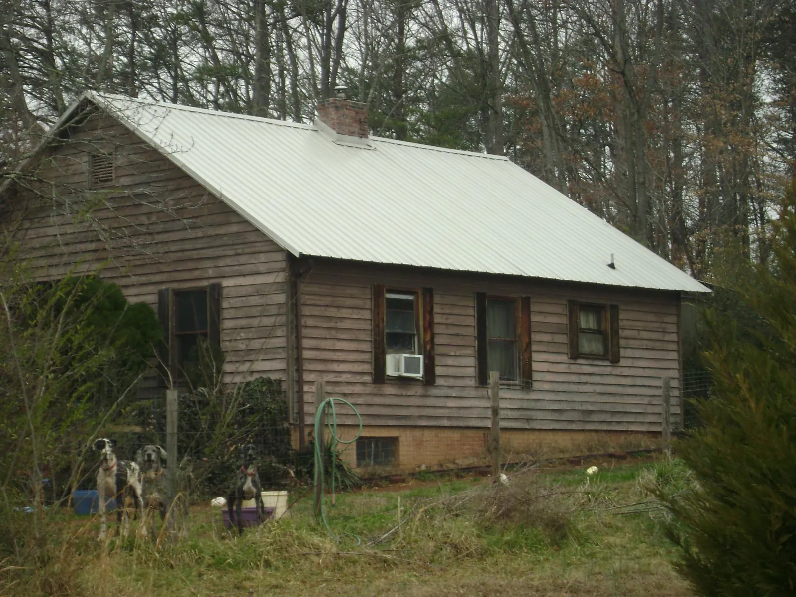 White metal roof on an old wood sided farmhouse, from a Metal Roof Installation job in Lookout Mountain